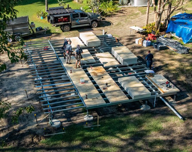 Suspended flooring system under construction, Platinum "R" Floor insulated panels laid over steel joists above a ventilated subfloor void