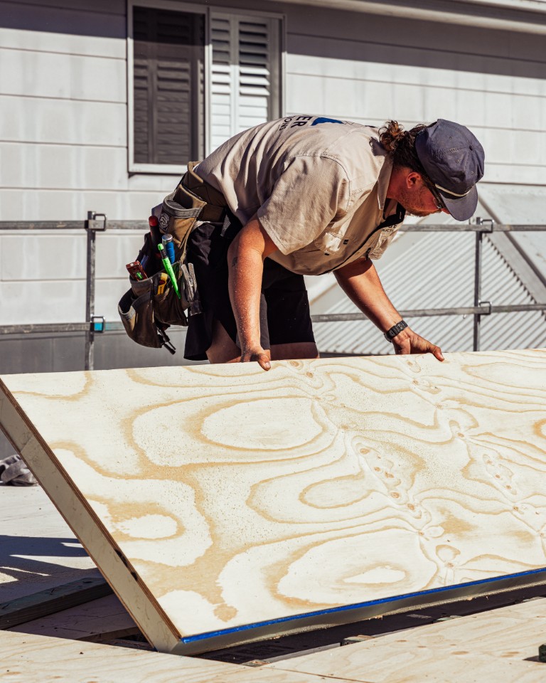 Squaring a Platinum "R" Floor panel into place against the scaffold, plywood grain showing