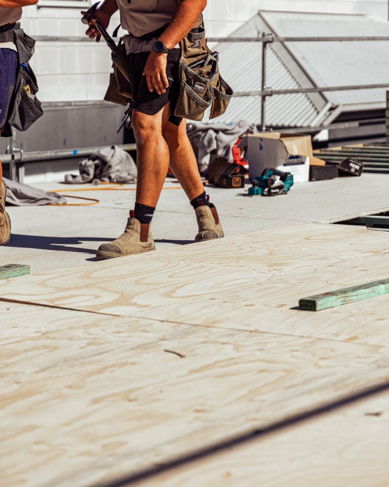 Installers walking across the finished Platinum "R" Floor with their tools