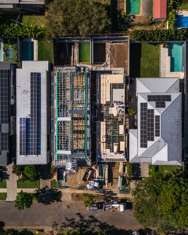 Drone view straight down on the Tarragindi build, its upper floor half laid between neighbouring homes