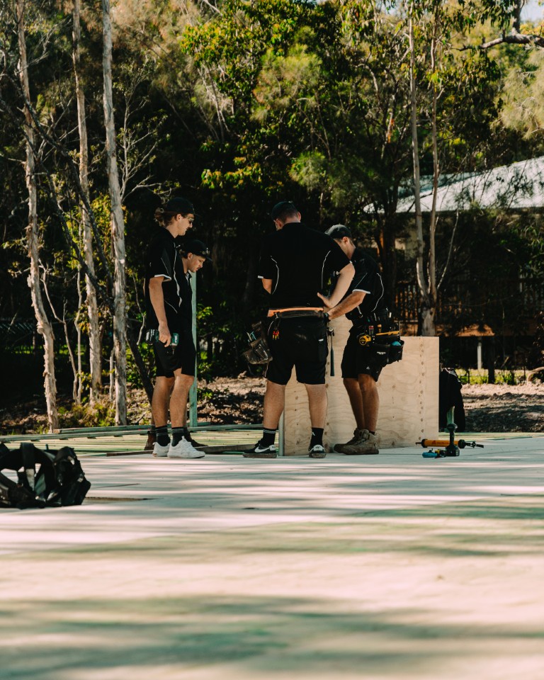 Installers standing on a newly laid Platinum "R" Floor among the gum trees at Weyba Downs